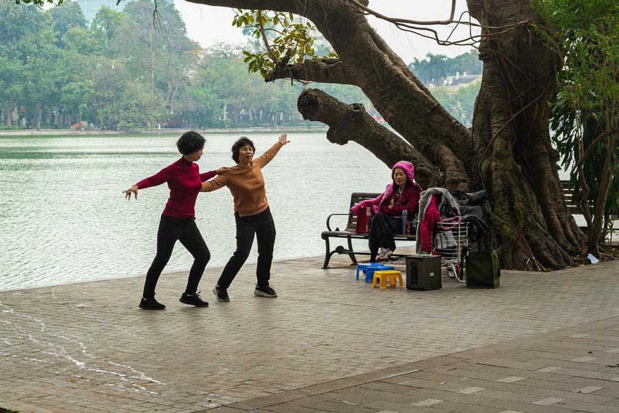 Dos mujeres mayores bailando junto a un lago